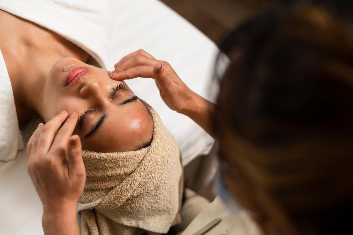 a woman getting her face prepared for a massage at Marriott Suites Pune in Pune