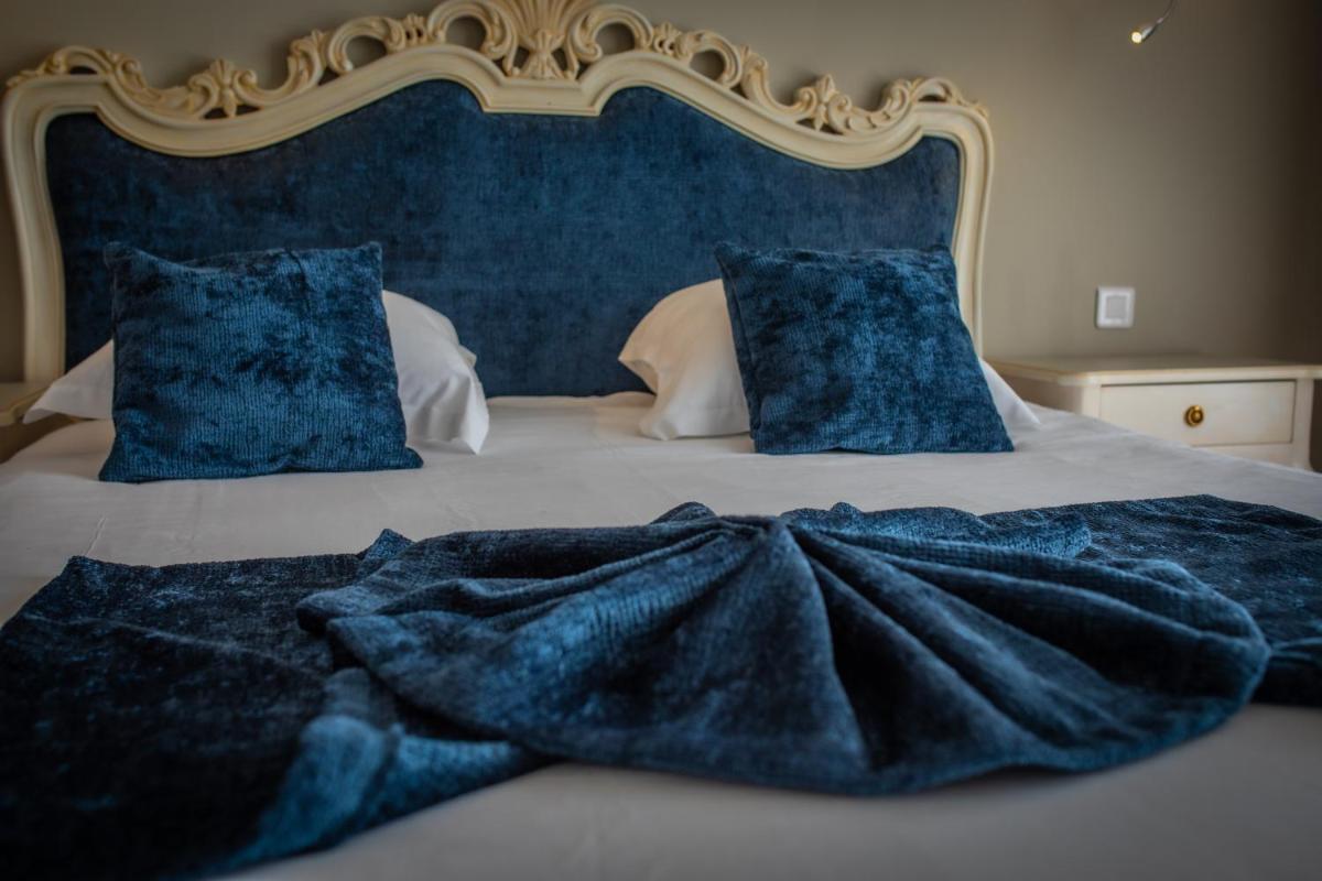 Un ou plusieurs lits dans un hébergement de l'établissement Alexain Hotel Restaurant & Wellness - Colmar Ouest