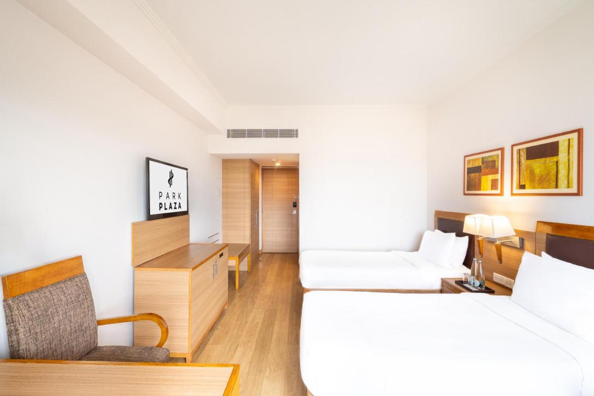 a hotel room with a bed and a desk at Park Plaza Chennai OMR in Chennai