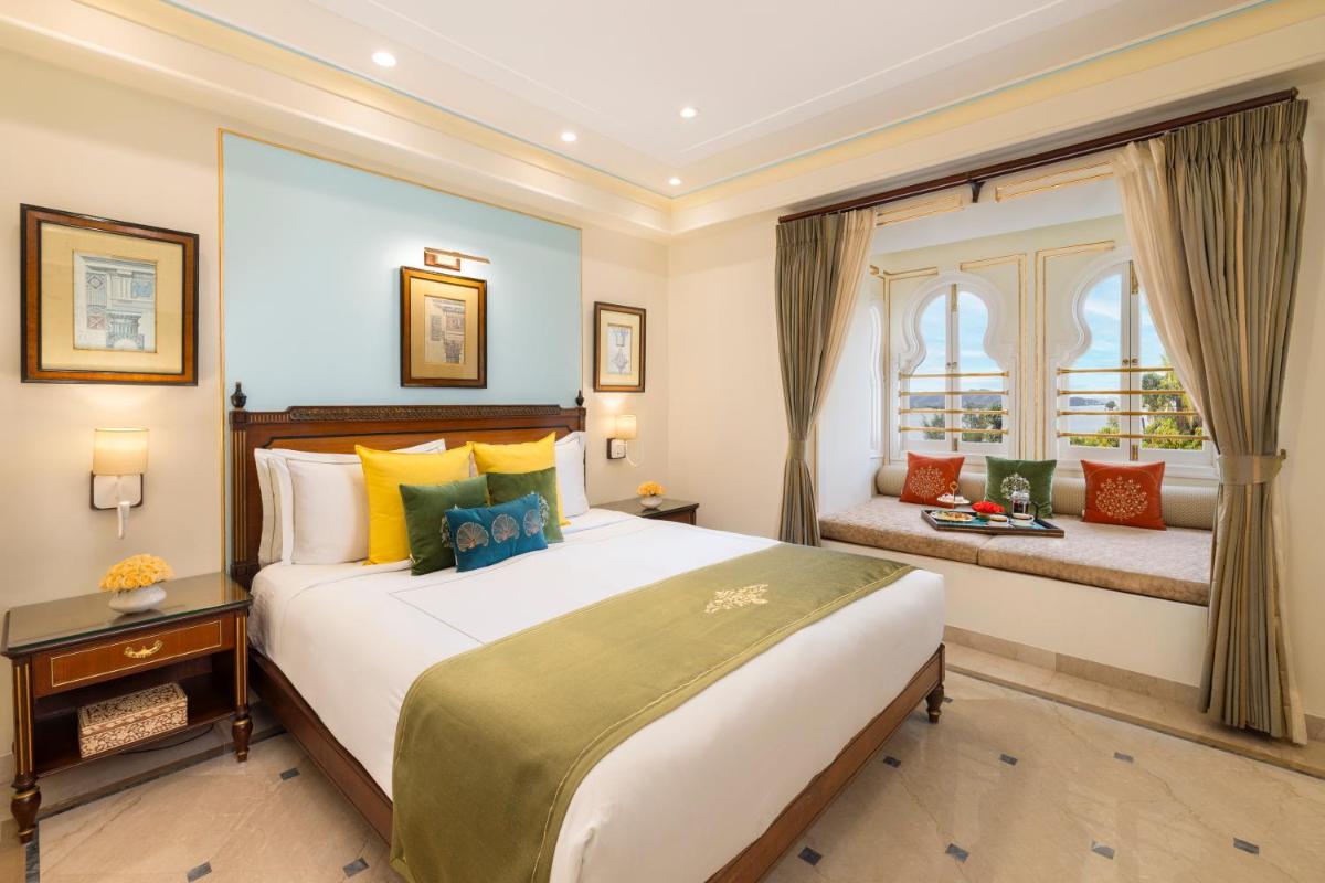a bedroom with a large bed and a window at Taj Fateh Prakash Palace Udaipur in Udaipur