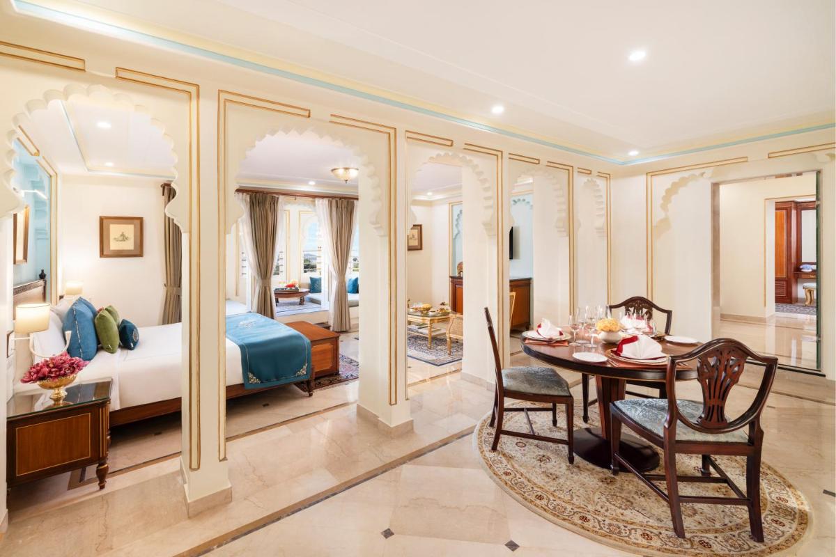 a bedroom with a bed and a table in a room at Taj Fateh Prakash Palace Udaipur in Udaipur
