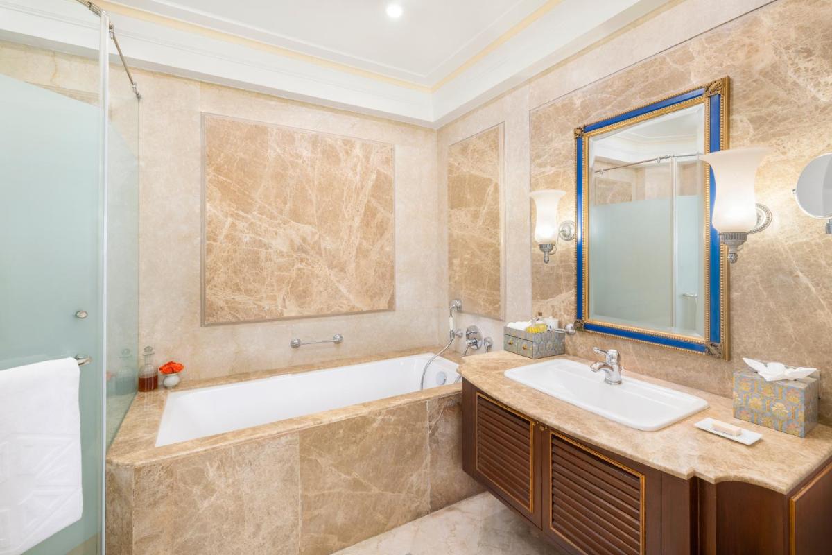 a bathroom with a tub and a sink at Taj Fateh Prakash Palace Udaipur in Udaipur