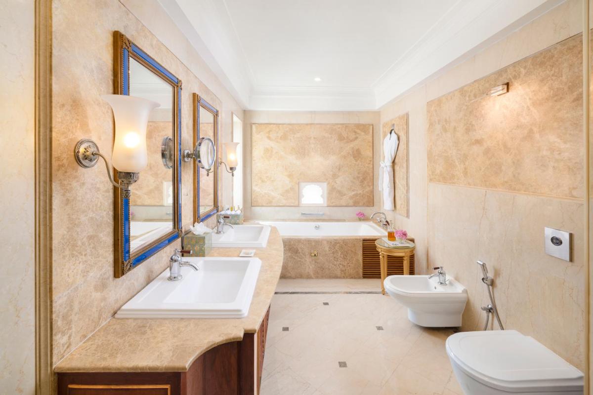 a bathroom with a sink and a toilet and a tub at Taj Fateh Prakash Palace Udaipur in Udaipur