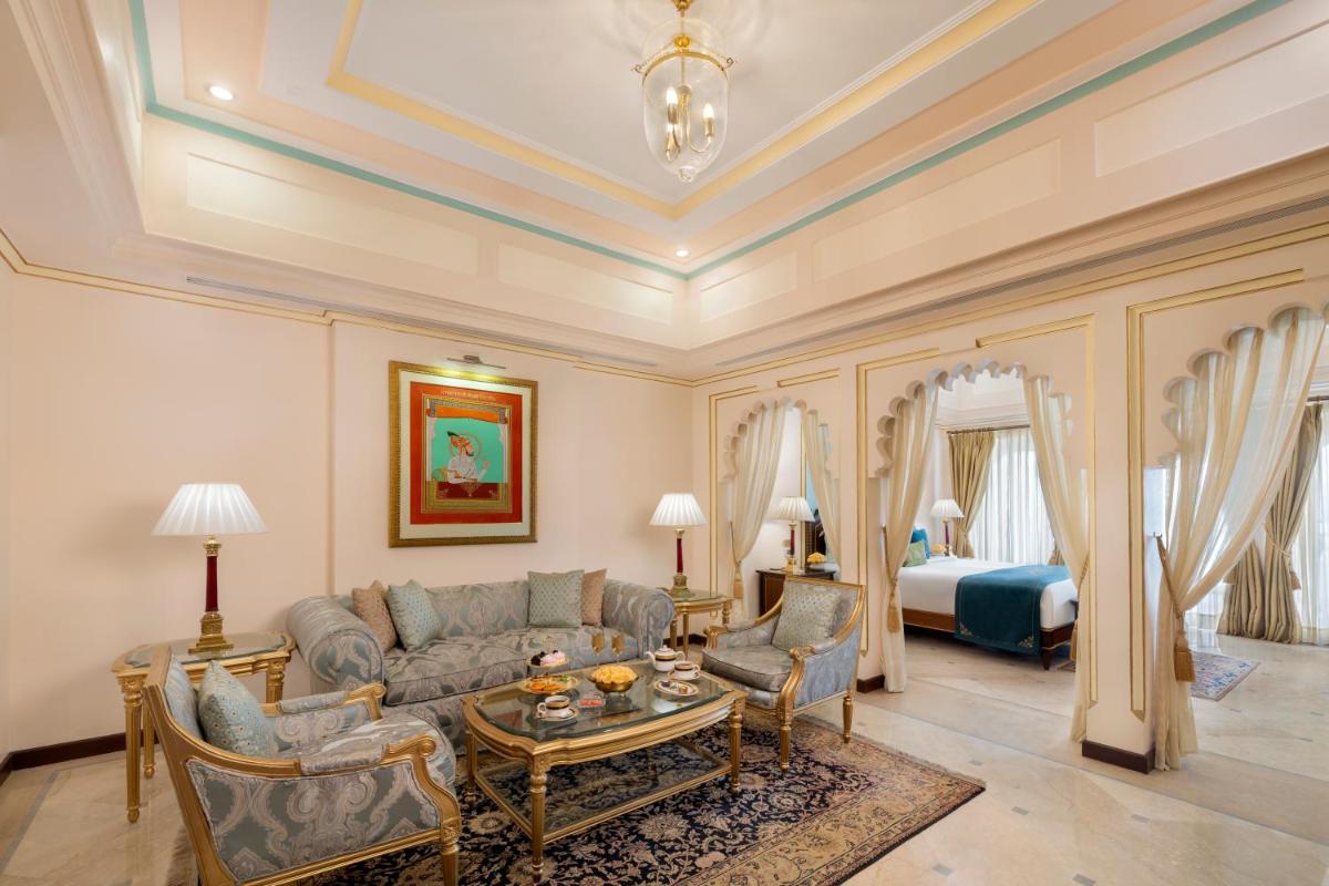 a living room with a couch and a bed at Taj Fateh Prakash Palace Udaipur in Udaipur