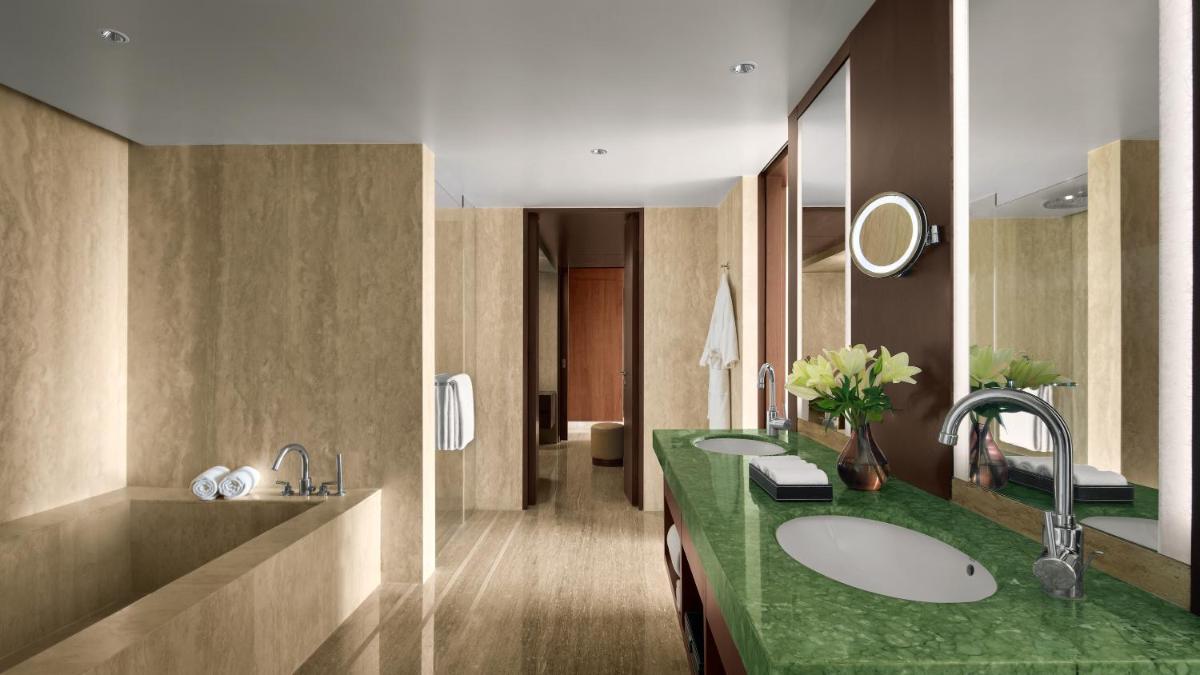 a bathroom with two sinks and a green counter at Park Hyatt Chennai in Chennai