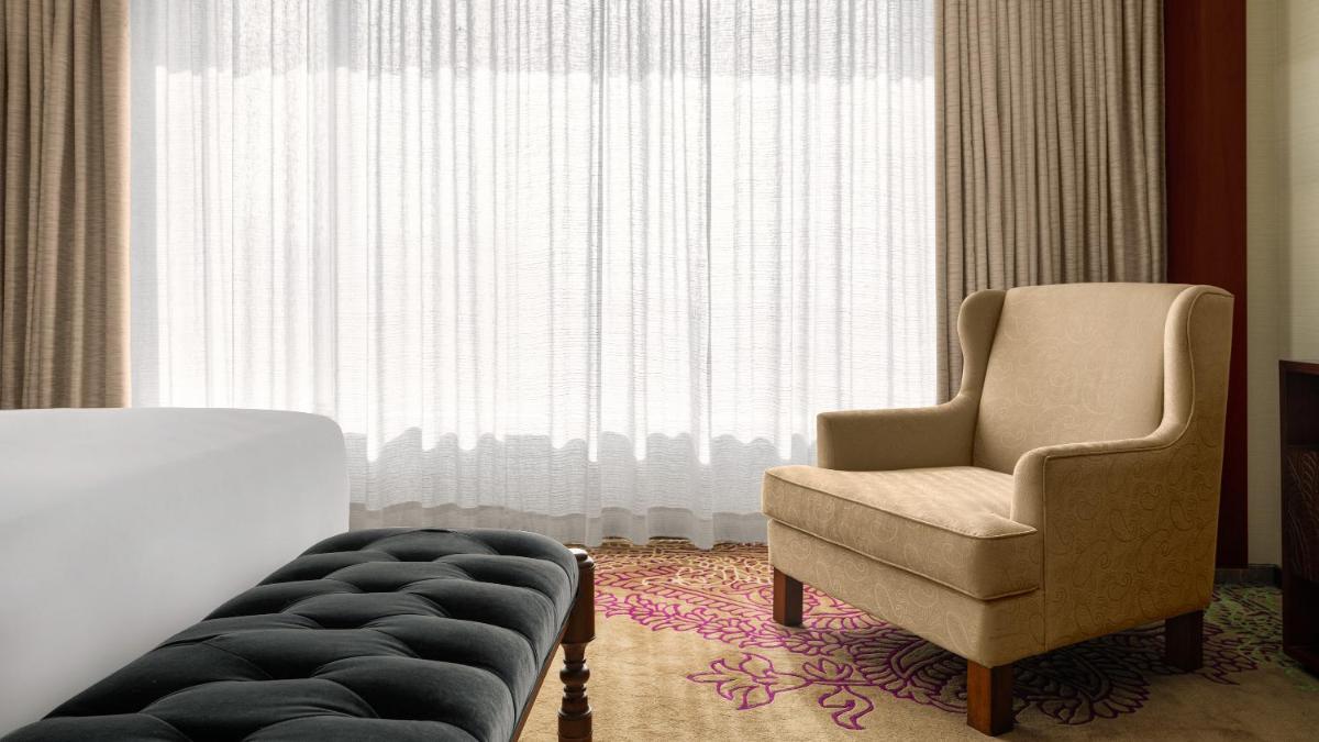 a living room with a chair and a chair at Park Hyatt Chennai in Chennai