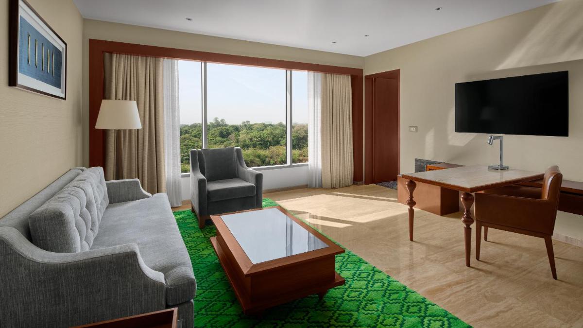 a living room with a couch and a television at Park Hyatt Chennai in Chennai