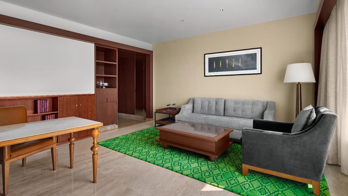 a living room with a couch and a table at Park Hyatt Chennai in Chennai