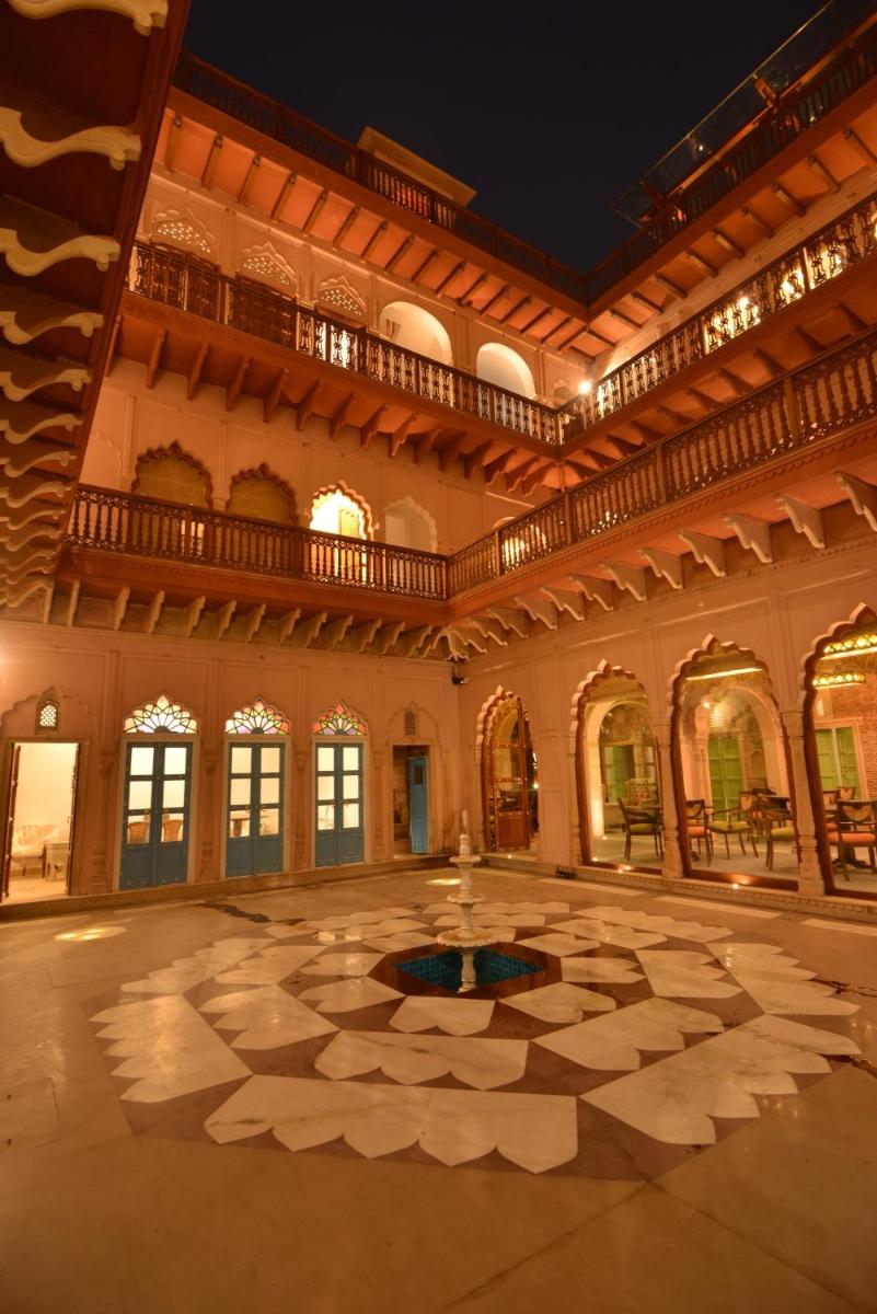 a large room with a fountain in the middle of a building at Haveli Dharampura & Golden Haveli- UNESCO awarded Boutique Heritage Hotel in New Delhi a large room with a fountain in the middle of a building at Haveli Dharampura & Golden Haveli- UNESCO awarded Boutique Heritage Hotel in New Delhi