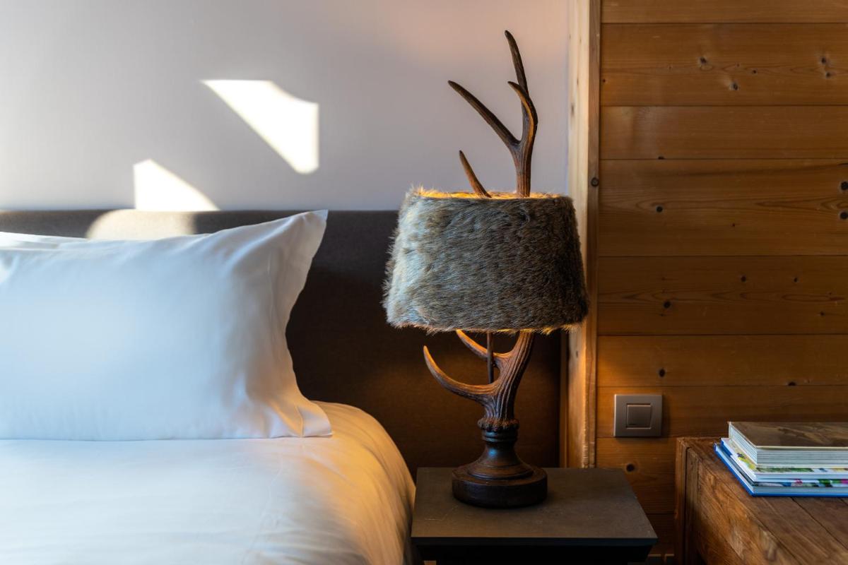 Un ou plusieurs lits dans un hébergement de l'établissement Chalet Hotel Kaya