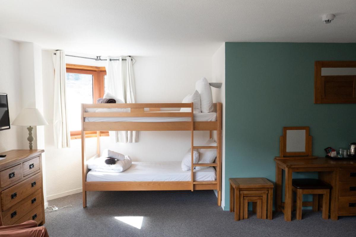 Un ou plusieurs lits dans un hébergement de l'établissement Hôtel Le Montana