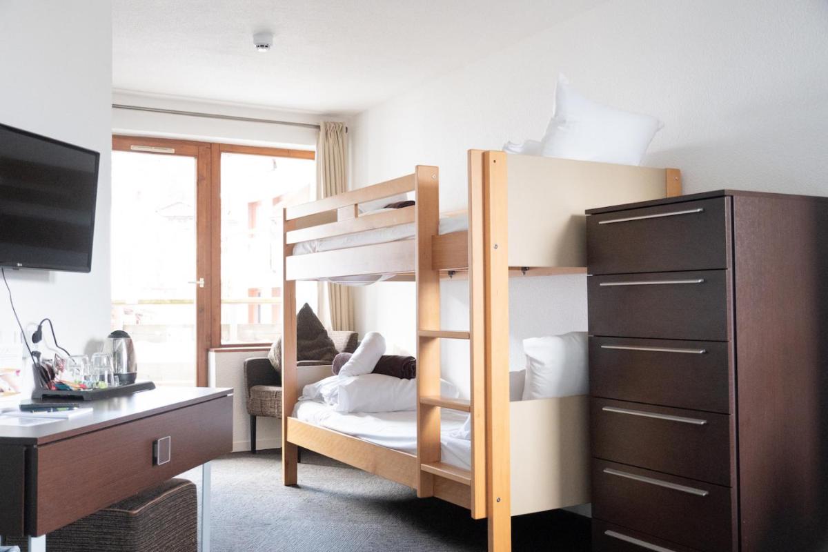 Un ou plusieurs lits dans un hébergement de l'établissement Hôtel Le Montana