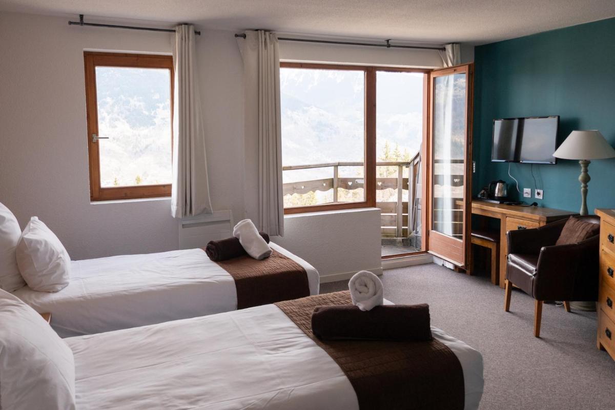 Un ou plusieurs lits dans un hébergement de l'établissement Hôtel Le Montana