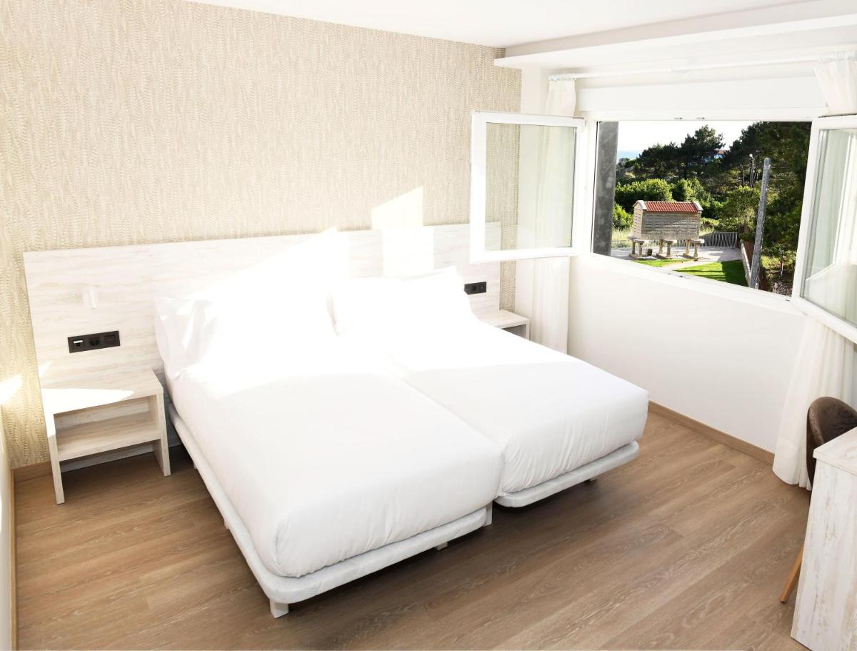 Cama o camas de una habitación en Hotel Spa Meiga do Mar