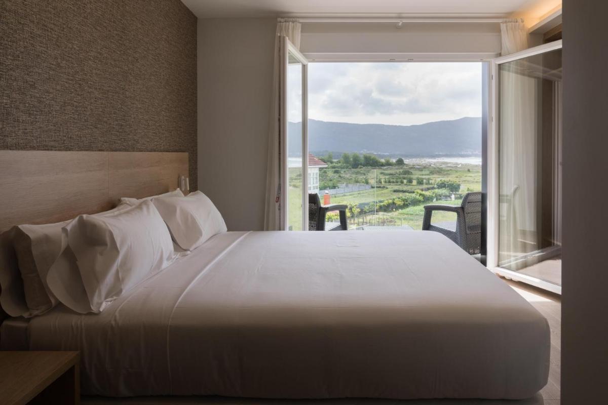 Cama o camas de una habitación en Hotel Spa Meiga do Mar
