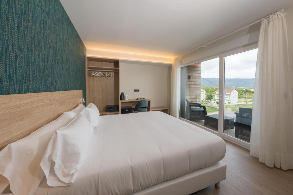 Cama o camas de una habitación en Hotel Spa Meiga do Mar