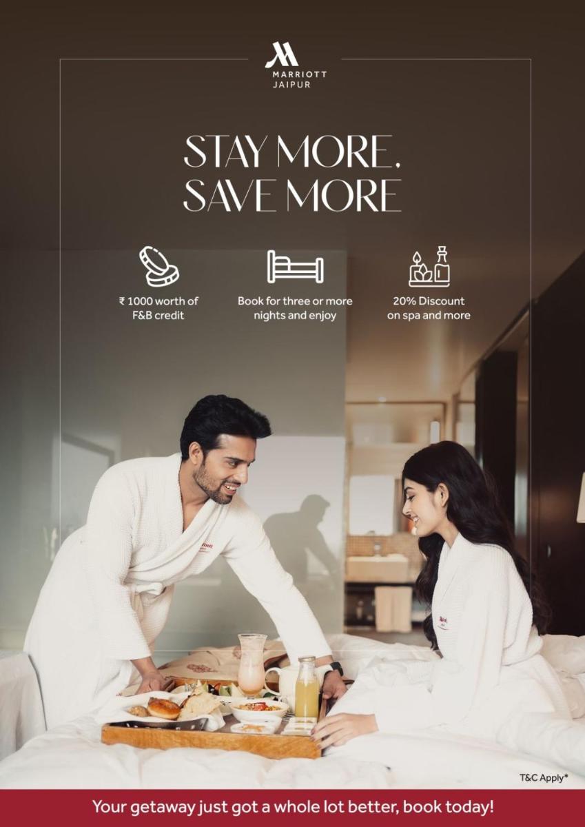 a poster of a man and a woman in a bed at Jaipur Marriott Hotel in Jaipur a poster of a man and a woman in a bed at Jaipur Marriott Hotel in Jaipur