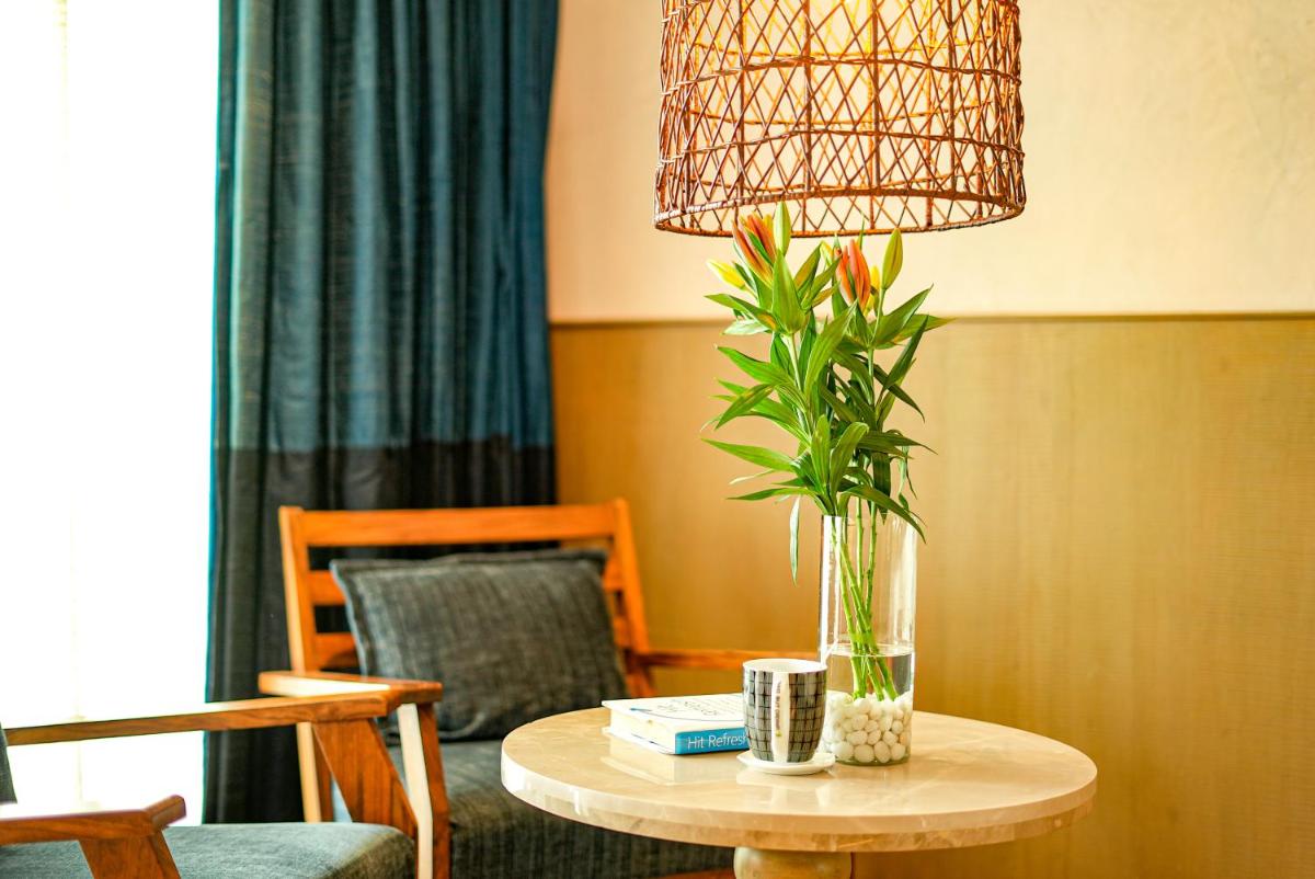 a table with a vase with a plant on it at The Park Bangalore, MG Road in Bengaluru a table with a vase with a plant on it at The Park Bangalore, MG Road in Bengaluru