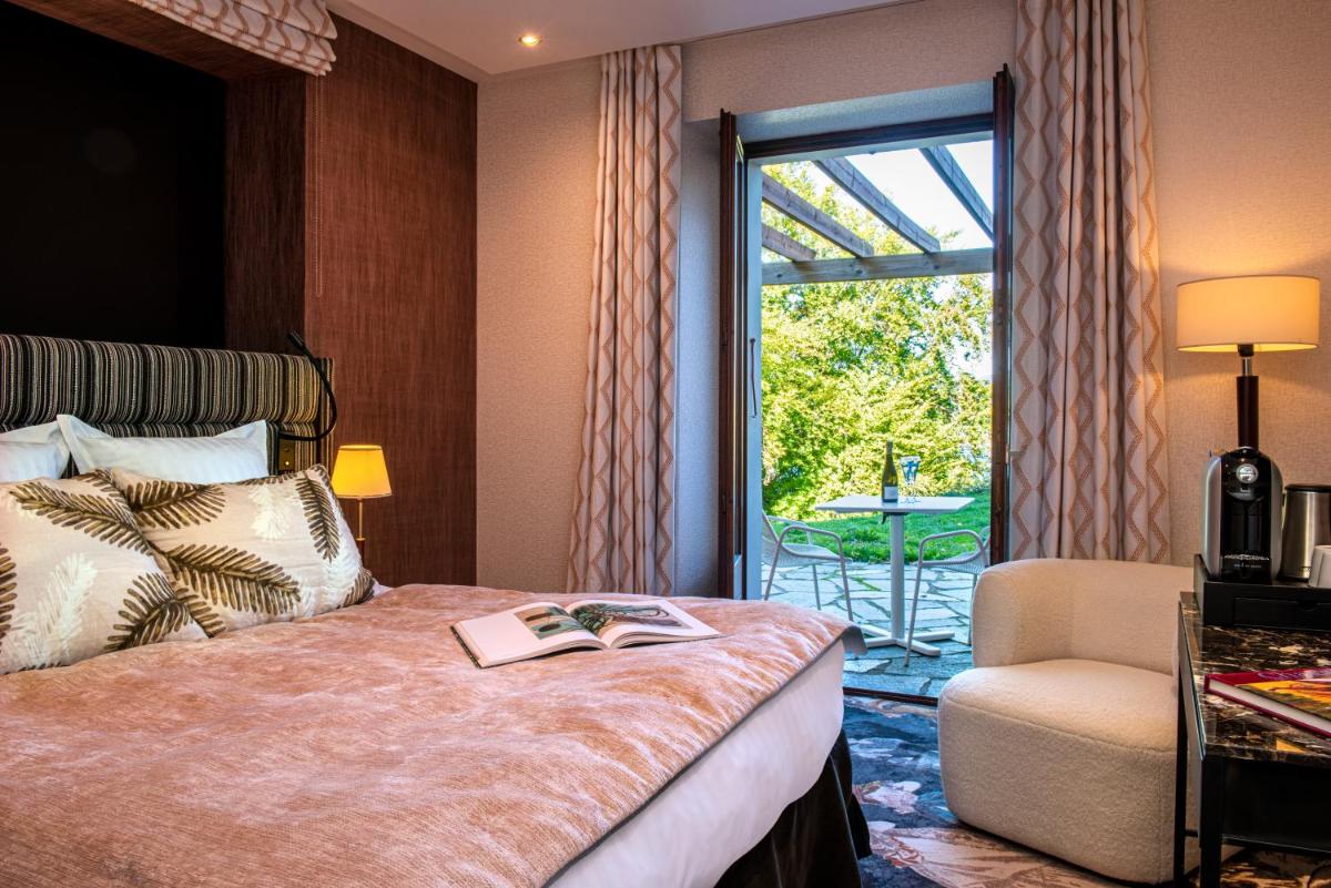 Un ou plusieurs lits dans un hébergement de l'établissement Les Trésoms Lake and Spa Resort