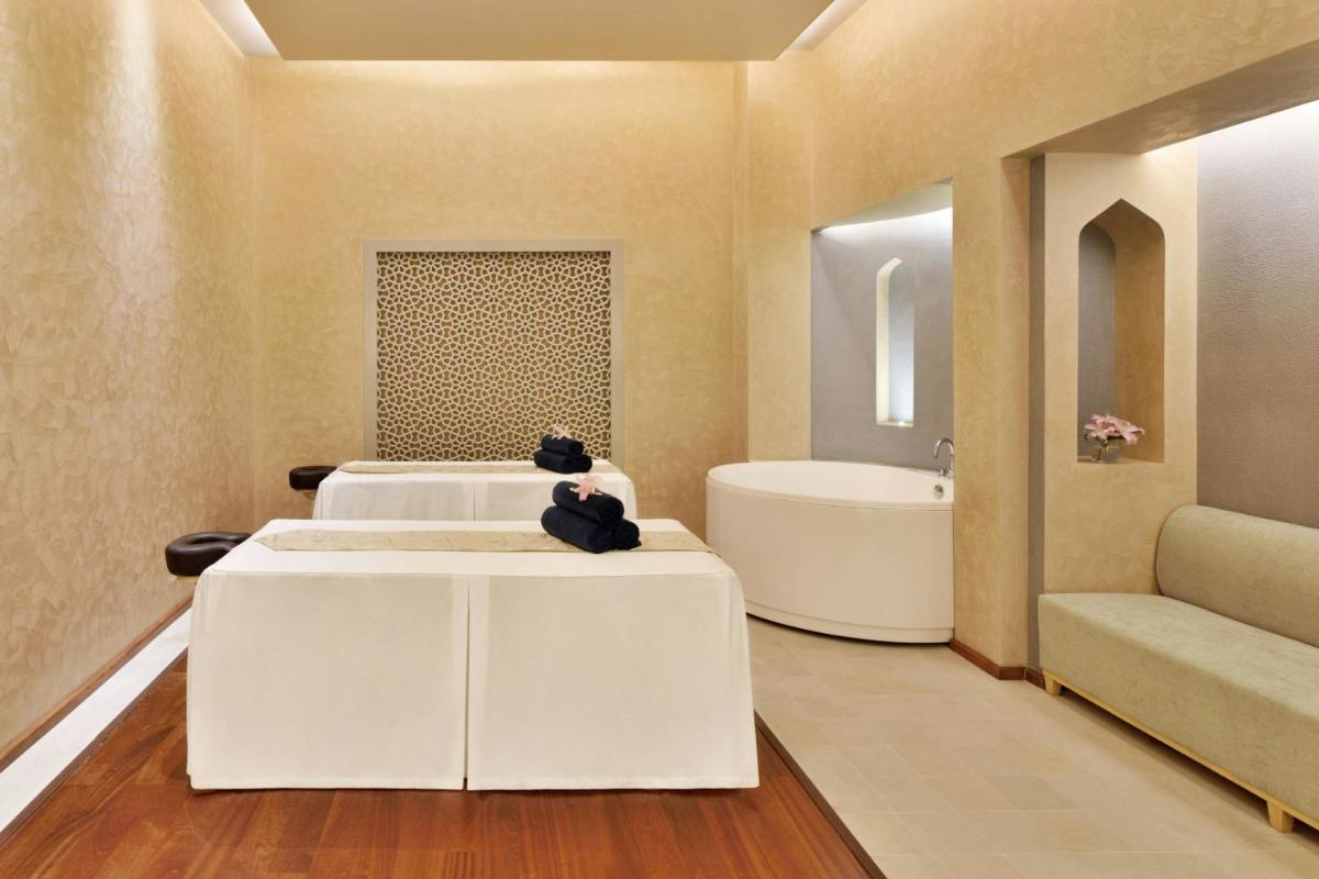 a bathroom with a tub and a sink and a bath tub at Le Meridien Jaipur Resort & Spa in Jaipur
