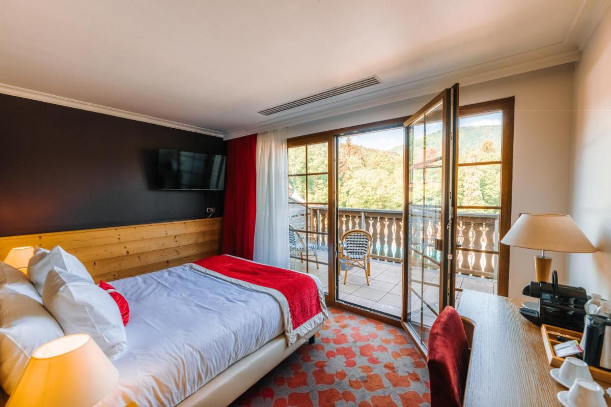 Un ou plusieurs lits dans un hébergement de l'établissement Les Violettes Hotel & Spa
