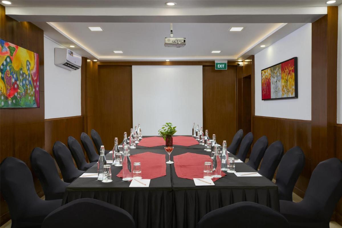 a conference room with a long table and chairs at Radisson Goa Candolim in Candolim