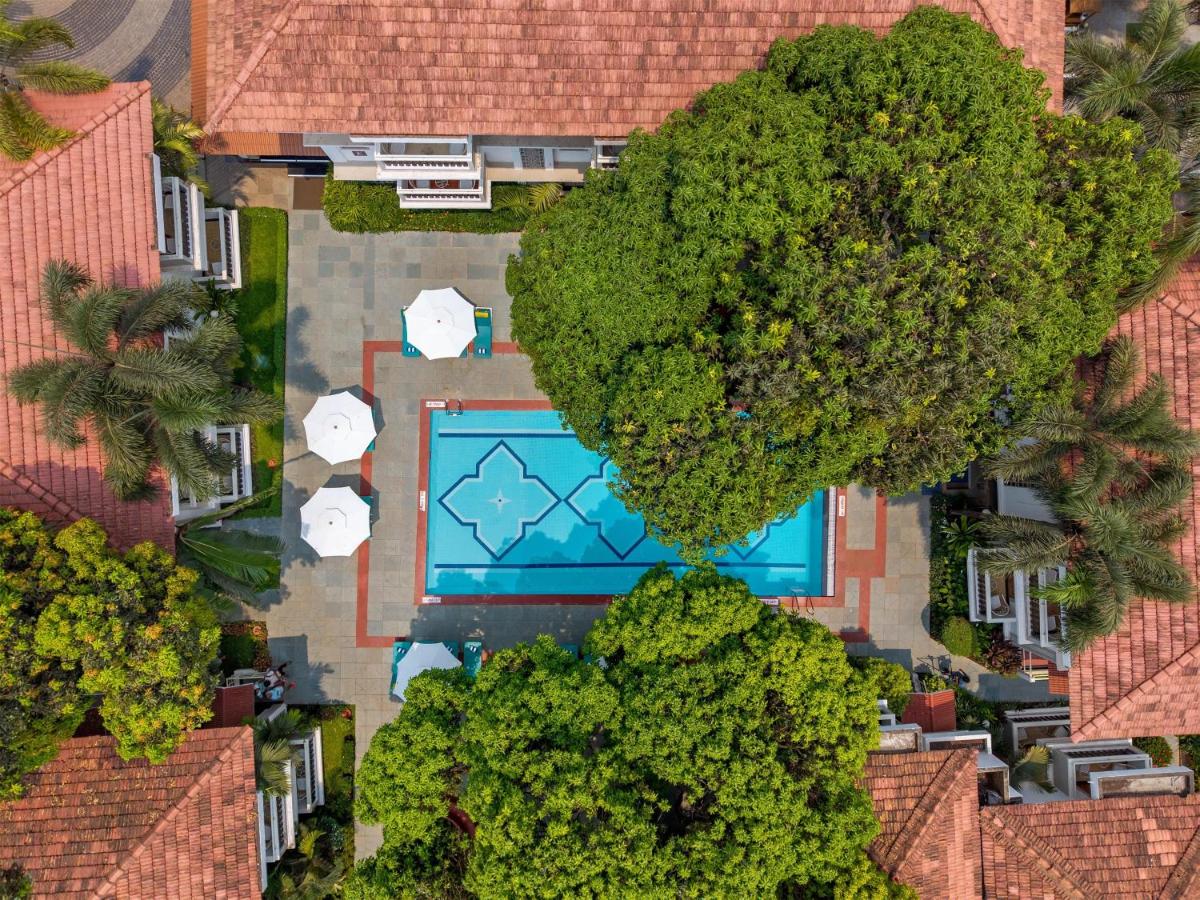an overhead view of a swimming pool surrounded by trees at Radisson Goa Candolim in Candolim