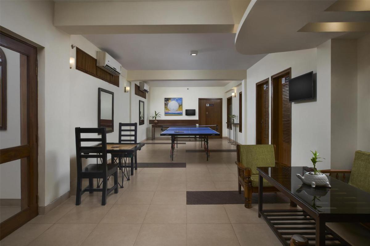 a dining room with a ping pong table and chairs at Radisson Goa Candolim in Candolim