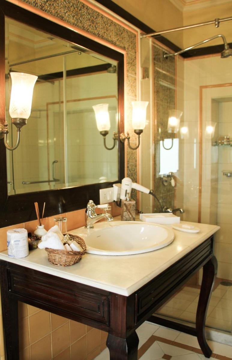 a bathroom with a sink and a large mirror at Royal Heritage Haveli - By Leisure Hotels in Jaipur