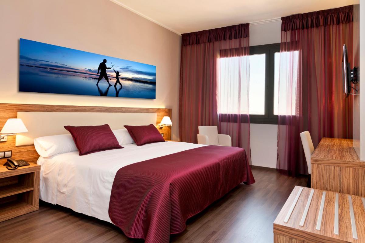 Cama o camas de una habitación en Dña Monse Hotel Spa & Golf