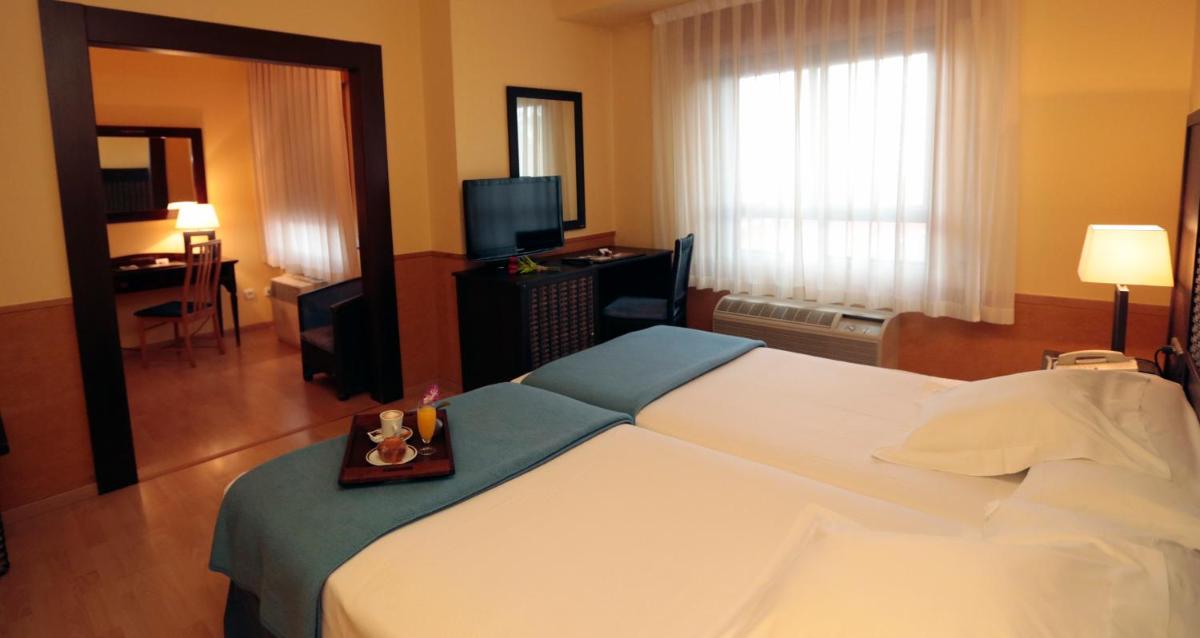 Cama o camas de una habitación en Hotel Spa Congreso