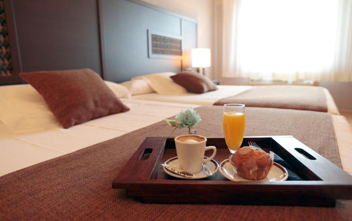 Cama o camas de una habitación en Hotel Spa Congreso