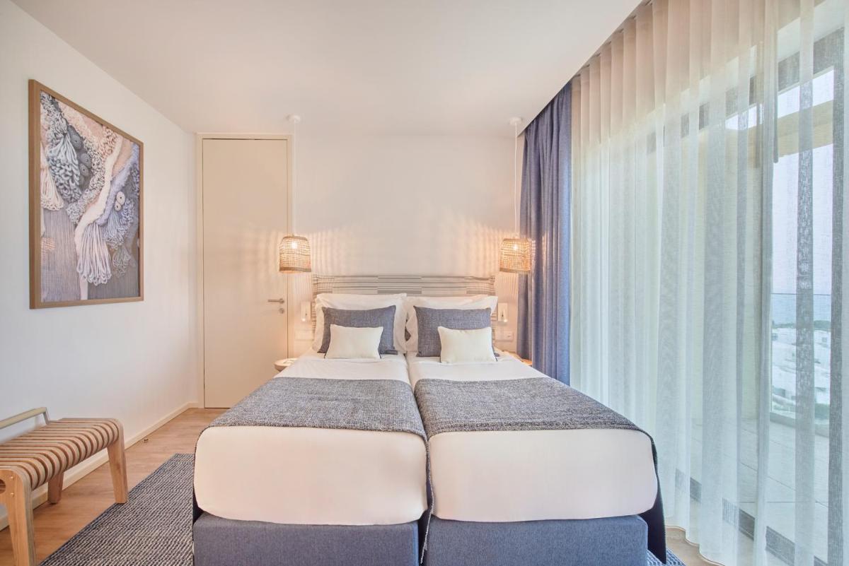 Uma cama ou camas num quarto em The Editory by the Sea Lagos