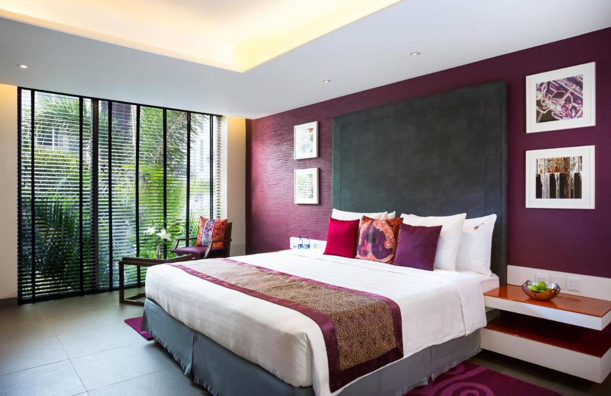 a bedroom with a large bed with purple walls at Hard Rock Hotel Goa Calangute in Calangute