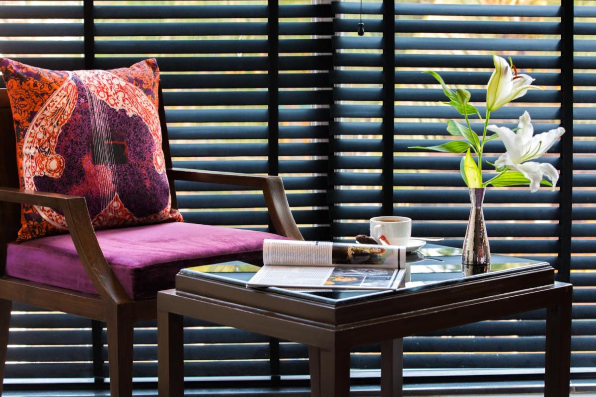 a room with a table and a purple chair with a table sidx sidx at Hard Rock Hotel Goa Calangute in Calangute