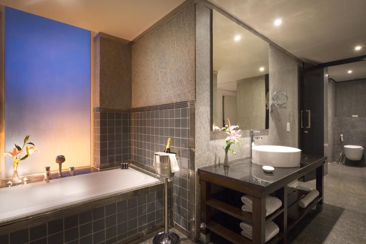 a bathroom with a tub and a sink at Hard Rock Hotel Goa Calangute in Calangute