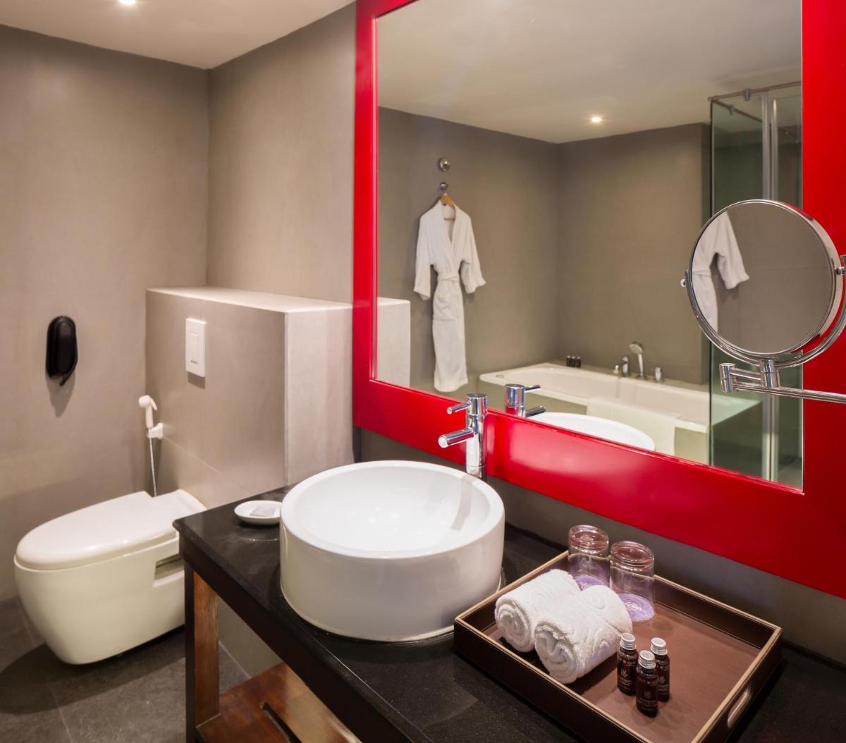 a bathroom with a sink and a toilet and a mirror at Hard Rock Hotel Goa Calangute in Calangute