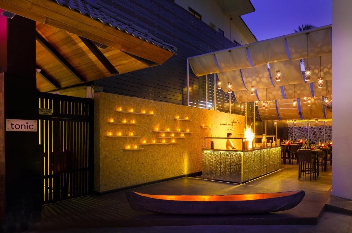 a restaurant with a table with lights on the wall at Hard Rock Hotel Goa Calangute in Calangute
