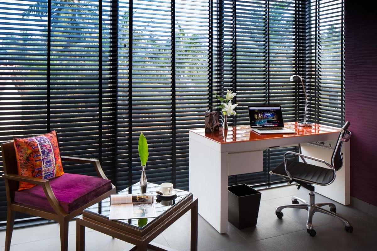 a office with a desk and a chair and a table at Hard Rock Hotel Goa Calangute in Calangute