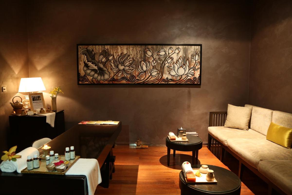 a living room with a couch and a table at Taj City Centre Gurugram in Gurgaon