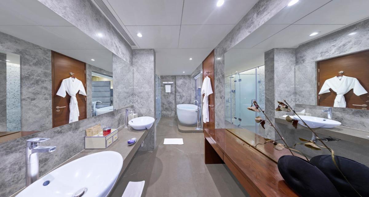 a bathroom with two sinks and two toilets at Vivanta Pune, Hinjawadi in Pune