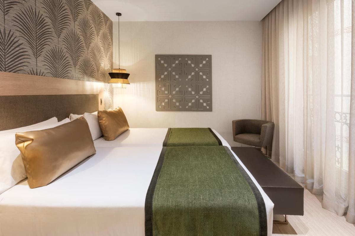 Cama o camas de una habitación en Catalonia Atocha