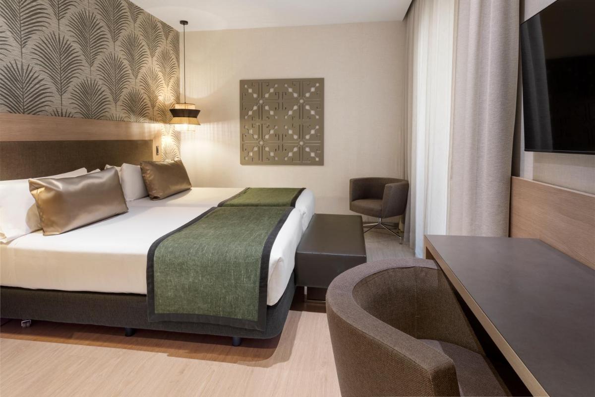 Cama o camas de una habitación en Catalonia Atocha