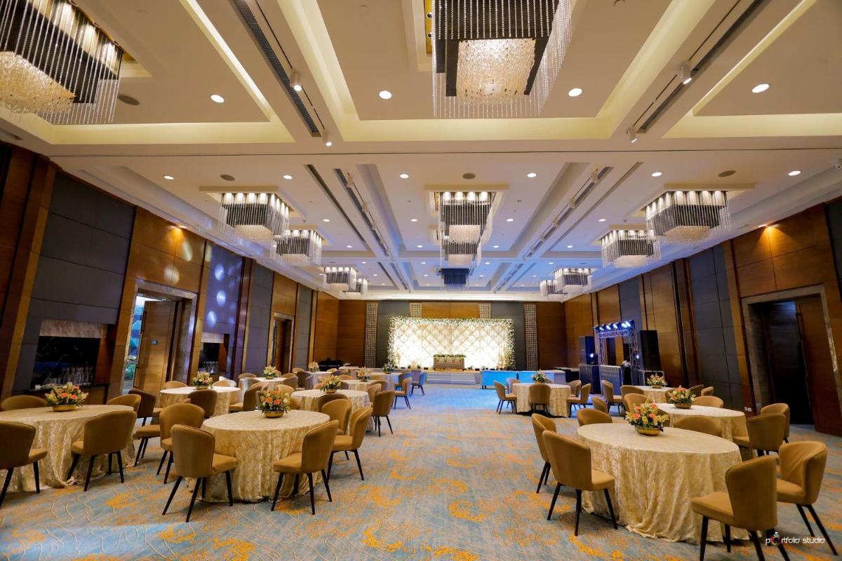 a banquet hall with tables and chairs and a stage at Crowne Plaza Today Gurugram by IHG in Gurgaon