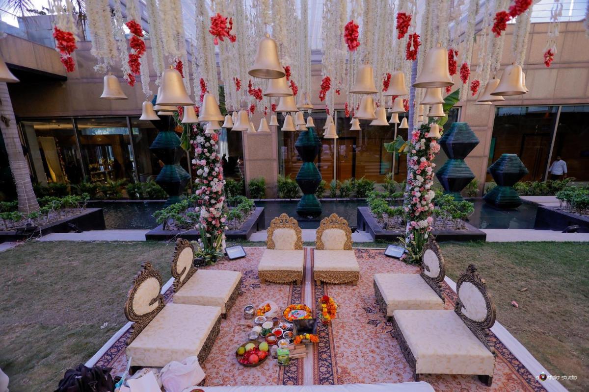 a courtyard with chairs and flowers in a building at Crowne Plaza Today Gurugram by IHG in Gurgaon