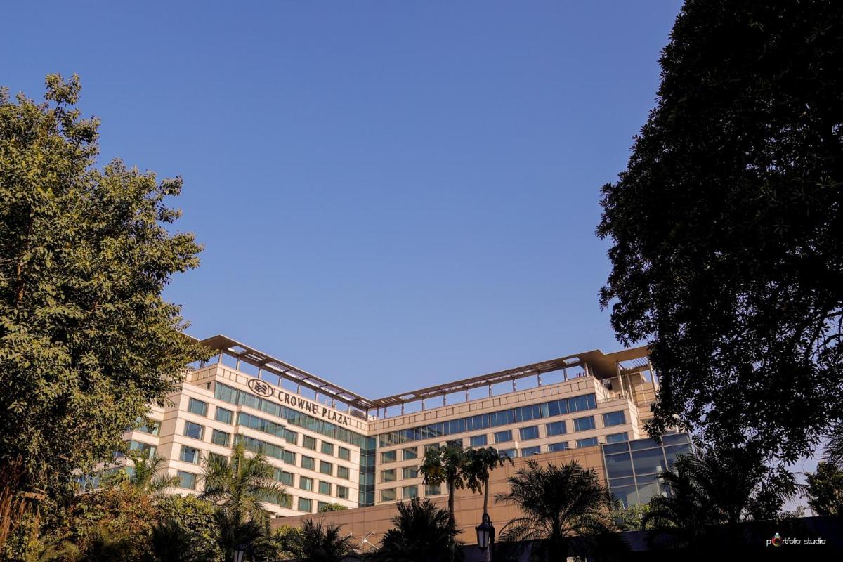 a large building with trees in front of it at Crowne Plaza Today Gurugram by IHG in Gurgaon