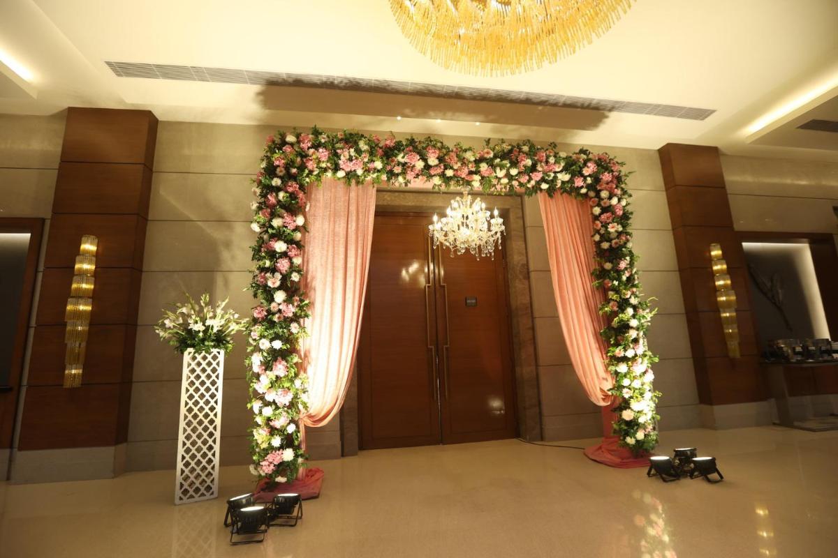 an entrance to a hotel lobby with a large doorway with flowers at Crowne Plaza Today Gurugram by IHG in Gurgaon