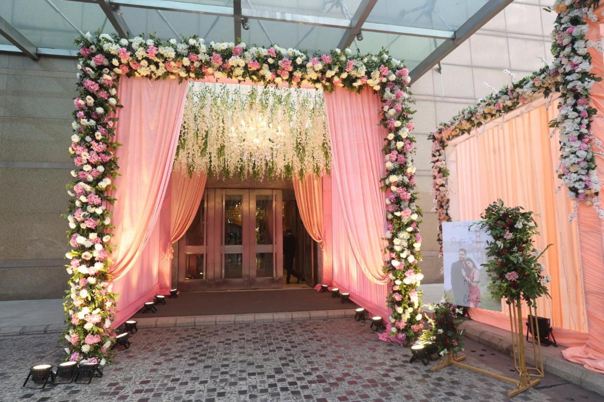 an entrance to a room with pink curtains and flowers at Crowne Plaza Today Gurugram by IHG in Gurgaon
