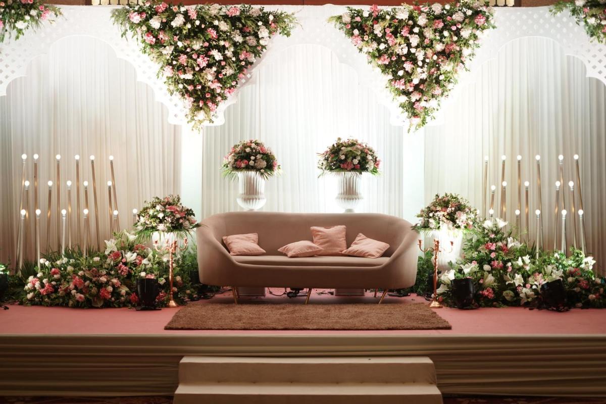 a living room with a couch in a room with flowers at Crowne Plaza Today Gurugram by IHG in Gurgaon
