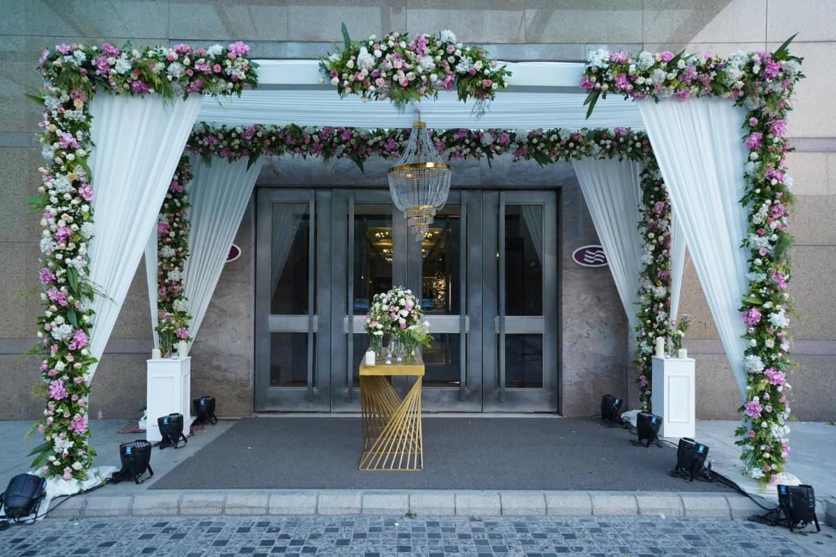 an entrance to a building with an arch with flowers at Crowne Plaza Today Gurugram by IHG in Gurgaon